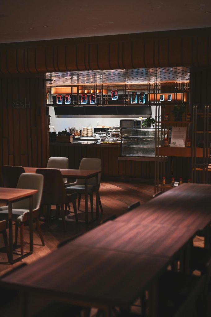 Warm, modern dining space with wooden tables and chairs, located in a Hong Kong café.