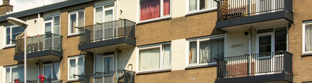 A sunny view of a modern apartment building facade in Voorburg, Netherlands.